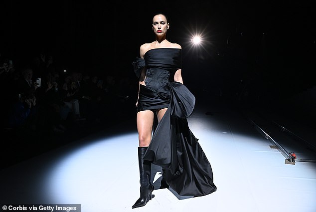 Turning heads: Rocking a red lip, Irina kept her poker face on as she strutted down the runway alongside the likes of Shalom Harlow, Eva Herzigova and Amber Valletta