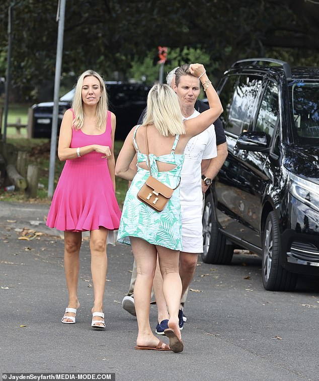 Roxy accessorized with brown flat sandals and a matching $14,500 Hermès bag