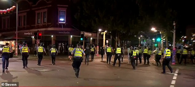 Two officers were sent to the hospital after being injured in the second fight, one with a shoulder wound and the other with a head wound (in the photo, the officers try to disperse the crowd during the riot)