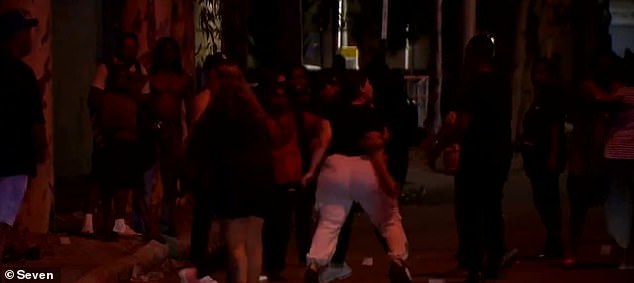 Authorities were trying to disperse the crowd when rioters threw the projectiles at the officers, police said (rioters at the scene pictured)