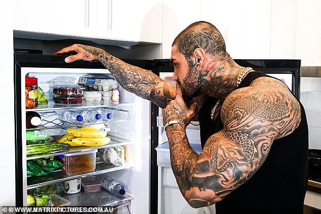 Balapour (above with his home fridge) normally trains seven days a week with weights and eats a lean, protein-rich diet of egg whites, skinless chicken breast, kimchi and lots of vegetables.