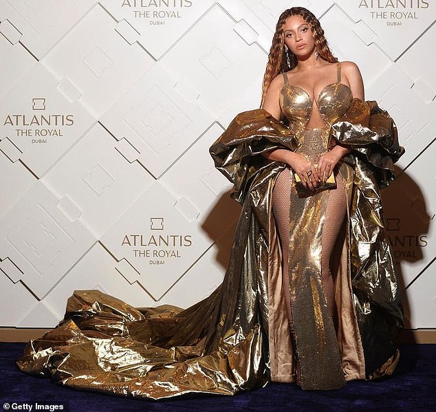 After the show: Beyonce put on a busty display in a sequined gold dress as she posed up a storm after her '$24 million performance'