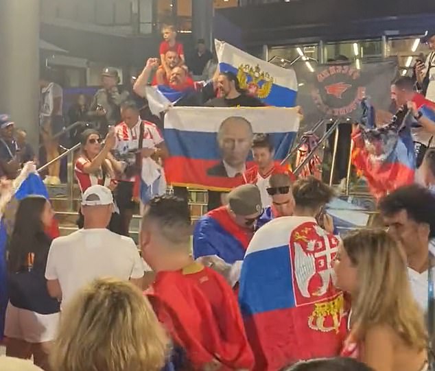 A Russian flag with the face of Vladimir Putin was unfurled on the steps of Rod Laver Arena after Djokovic reached the semifinals.