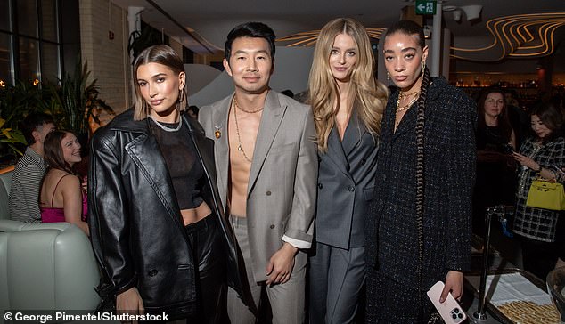 Man of the hour: Making his way through the event, the We Were Dreamers author hung out with catwalk sensations Hailey Bieber (26, far left) Kate Bock (34, center right) and Reign Judge (21, far right)