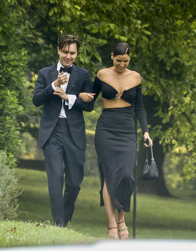 Tahnee Atkinson (left) looked chic in a black crop top and matching skirt with a slit