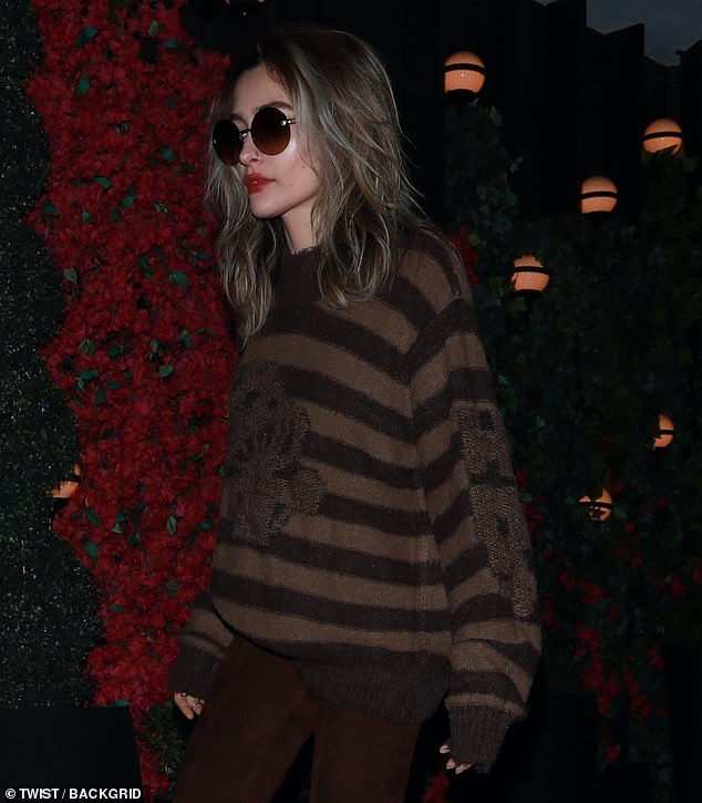 Stylish: The late icon Michael Jackson's 24-year-old daughter left the ritzy restaurant in her oversized dark sweater while hiding behind a striking pair of round sunglasses