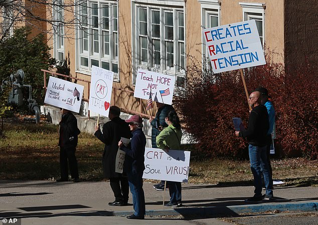 People protest outside the New Mexico Public Education Department offices, Friday, November 12, 2021