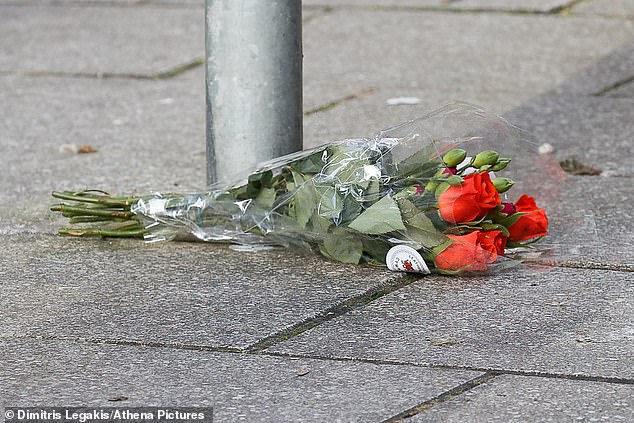 A bouquet of flowers is left near the crime scene as tributes from the local LGBTQ+ community arrive.