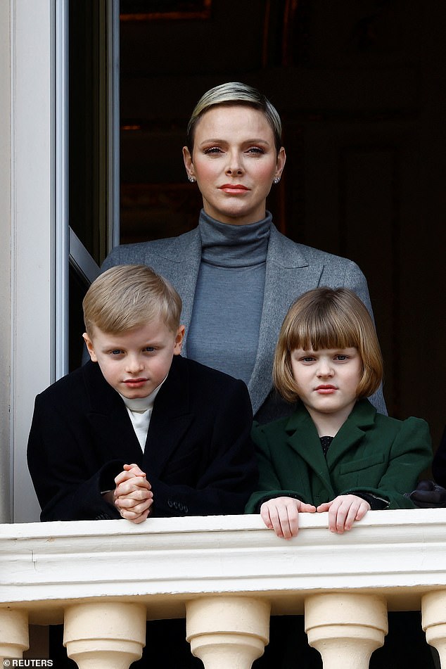 The eight-year-old twins paid attention as the traditional procession of Santa Devota passed by.