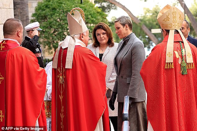 The princess appeared serene and in good spirits when she was received by the country's archbishop and other dignitaries at the Monaco Cathedral.