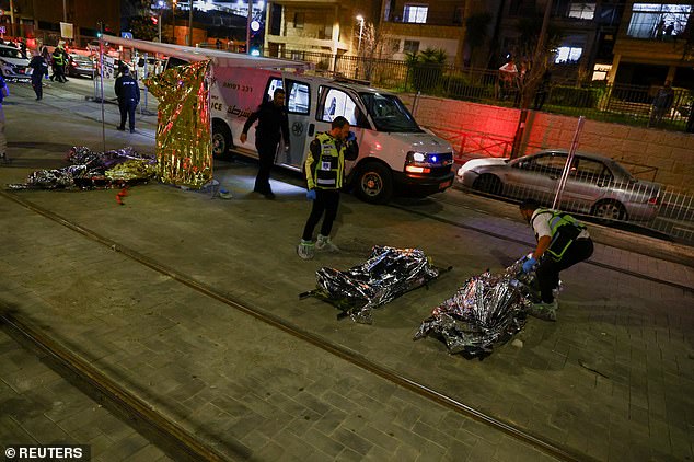 Israeli forces work near the scene of a shooting attack in Neve Yaacov