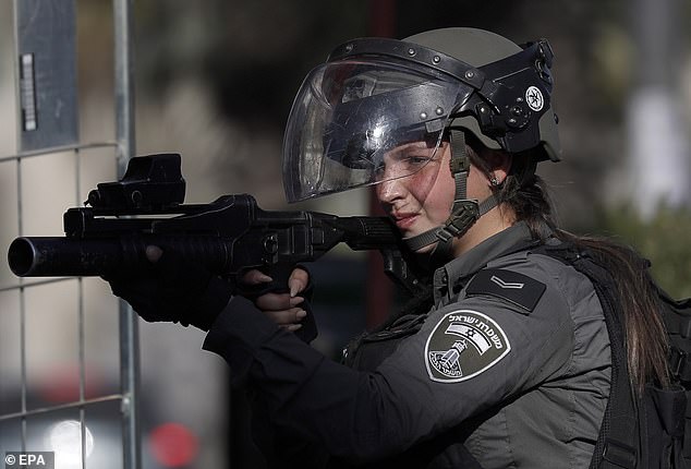 Israeli border police clash with Palestinian stone throwers in the town of A-Ram, north of Jerusalem, on January 27, 2023, as Palestinians from across the West Bank protest to condemn the killing of nine Palestinians in the Jenin refugee camp during an Israeli raid on January 26, 2023