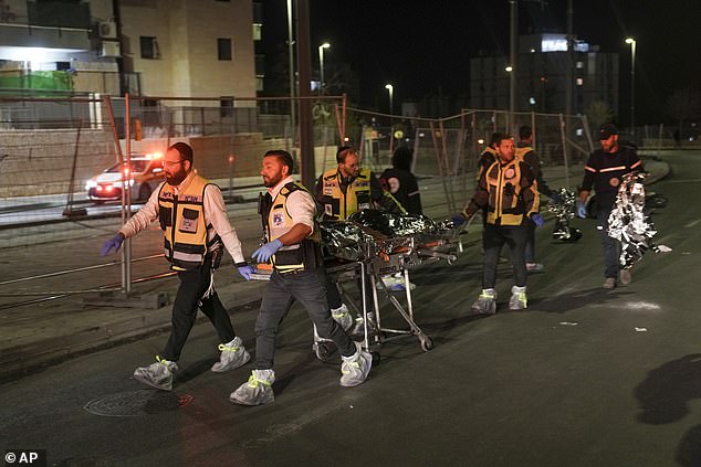 Members of the Zakah Rescue and Recovery team evacuate a body after a shooting attack near a synagogue in Jerusalem