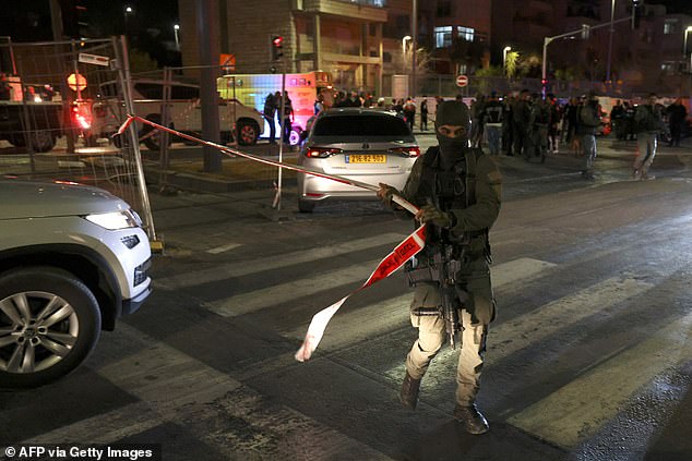 Israeli security forces cordon off the site of an alleged attack in a settler neighborhood