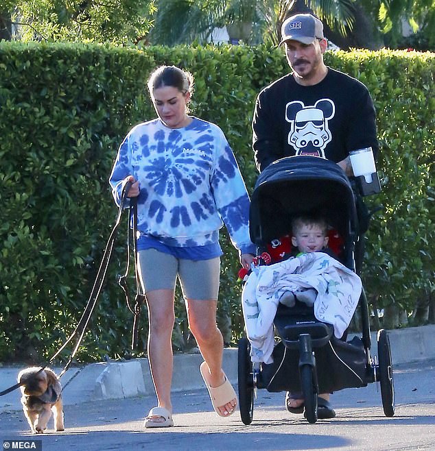 A family of three: the two seemed serious as they pushed their son.