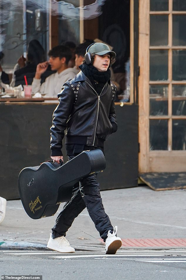 Leather look: The 27-year-old actor donned a black leather jacket and a pair of jeans  A thick matching scarf wrapped around his slender neck.