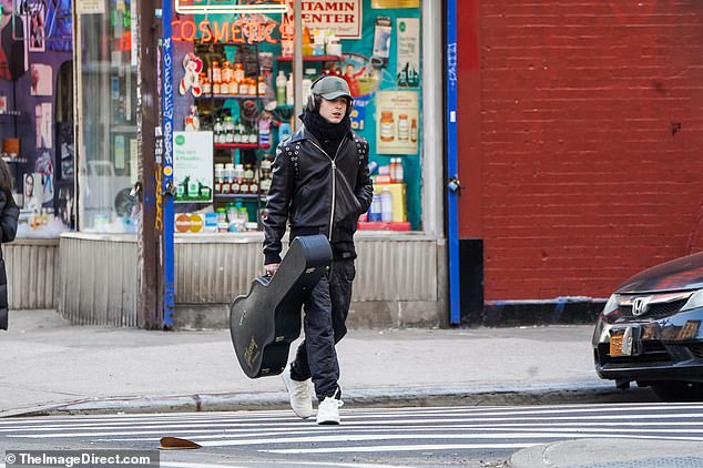 Guitar: Chalamet carried a large guitar case in his right hand as he walked through the streets of the Big Apple.