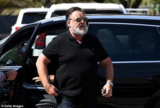 Disregarding the Queensland heat, he donned a pair of black jeans and a black polo shirt while accessorizing himself with a designer silver watch.