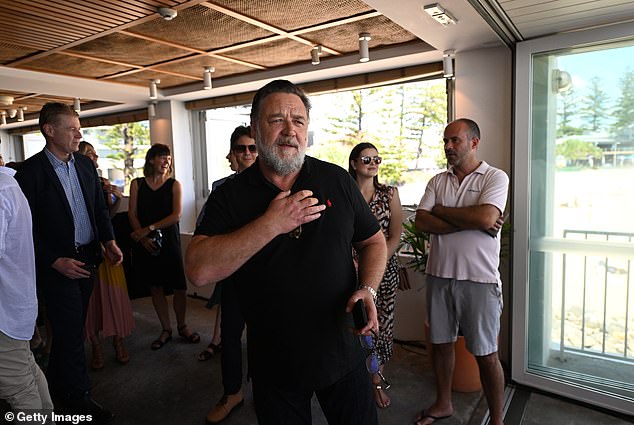 Here Crowe is shown swapping his sunglasses for reading glasses as he walked to the podium.