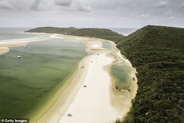 Rainbow Beach on Queensland's Cooloola coast ranked number three (pictured), with 4WDs on the sand and sailboats anchored in shallow water)