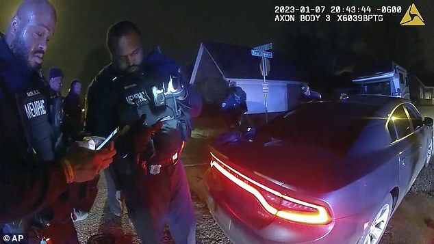 Cops are seen standing next to the type of unmarked Dodge Charger favored by SCORPION teams, following the January 7 beating of Tire Nichols after a traffic stop.