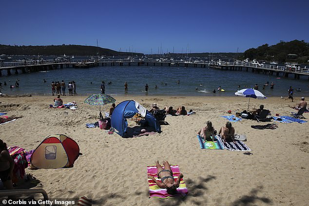 Australians are advised to wear a hat, shirt, sunglasses and sunscreen, but also seek shade (pictured, sunbathers at Balmoral Beach in Sydney)