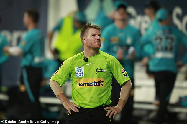 Warner looks on during a rain delay in the Big Bash League knockout final between the Sydney Thunder and the Brisbane Heat at the Sydney Showground