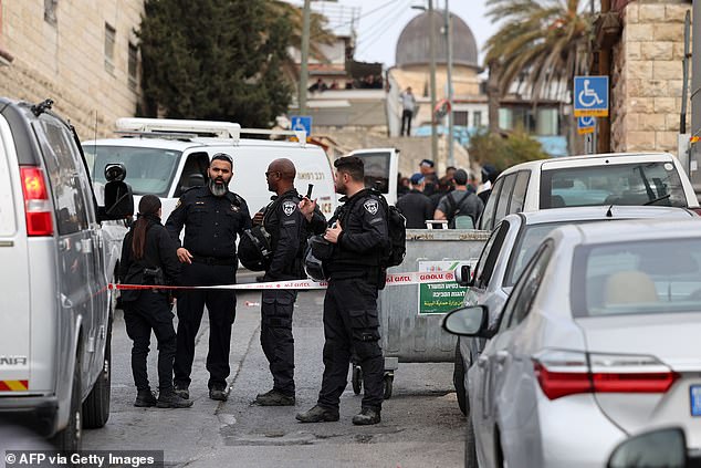 Israeli security forces gather in the predominantly Arab neighborhood of Silwan in Jerusalem, where an attacker reportedly shot and wounded two people.