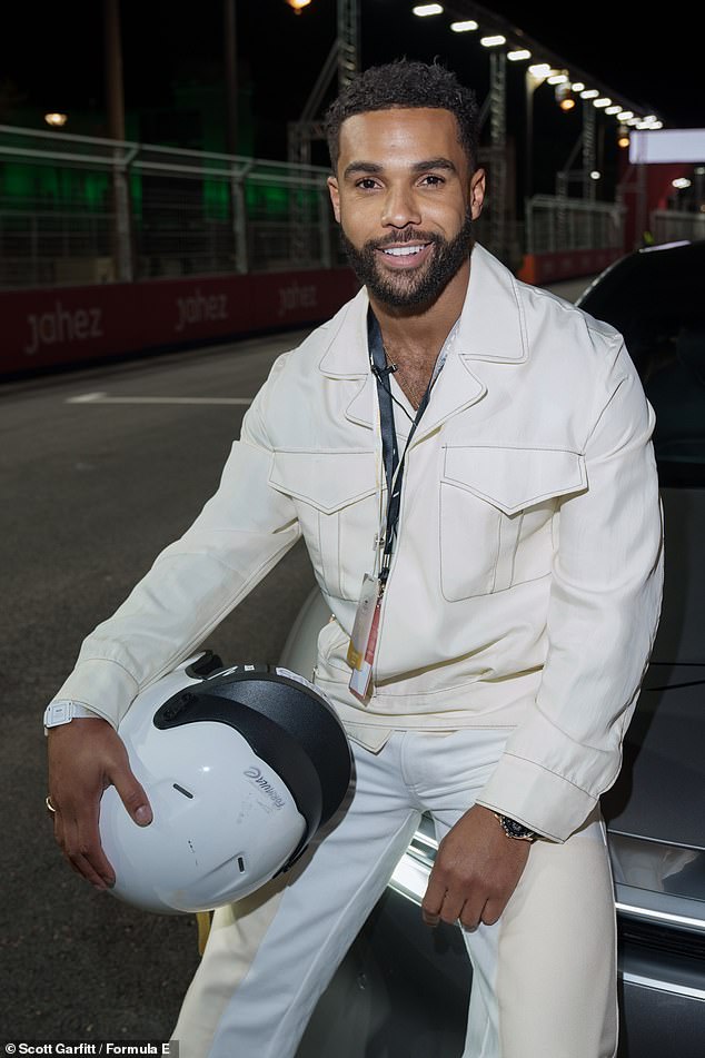 Model credentials: Lucien posed with his helmet on in one of the expensive electric cars