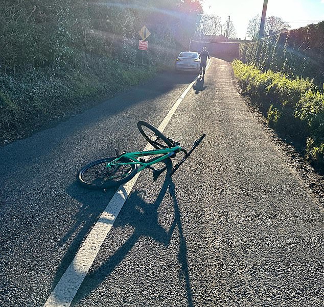 Incident: McGregor's wrinkled turquoise racing bike could be seen on the ground with a gray car several yards ahead