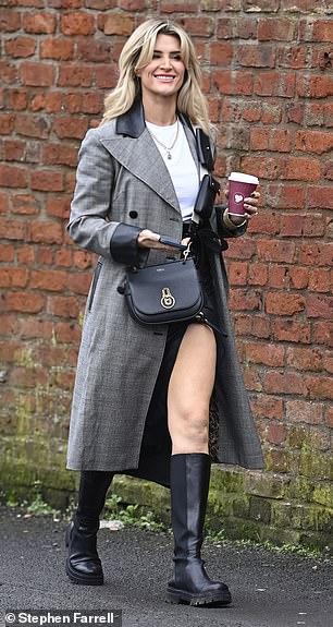 Perfectly coordinated: The soap opera star's gold jewelry and chunky black boots matched her quirky black strappy Mulberry bag.