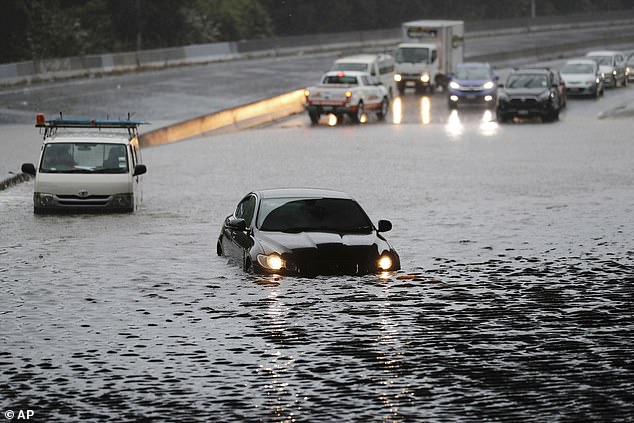 Major roads have been blocked by devastating flooding, causing long traffic queues on motorways (above)