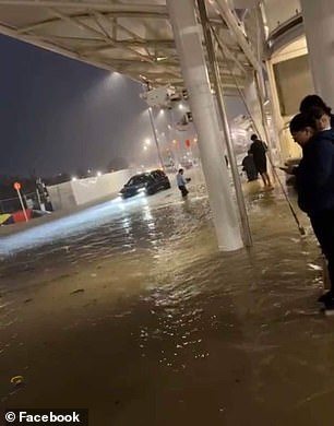 Travelers stranded at Auckland's domestic and international airports as floodwaters rise (pictured Friday night)