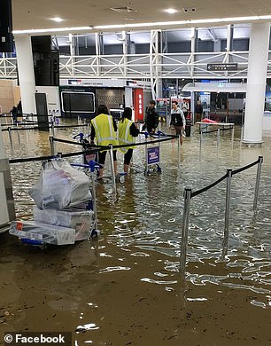 Travelers were stranded as floodwaters inundated airports (pictured Friday night)