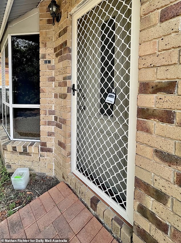 A padlock could be seen attached to the screen door on Wednesday, with a stack of plastic bins below the front window.