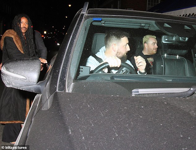 Taking a back seat: Sam sat in the back of the car as they are driven out on their night of celebration.