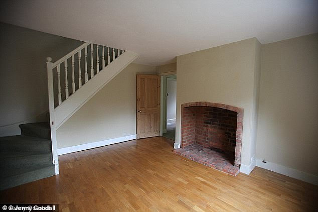 An open brick fireplace and slim staircase were the main features of the small living room and dining room.