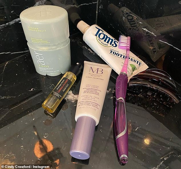 Beauty mainstays: Crawford also posted a photo of her bathroom counter, showing off some of her beauty staples: Tom's toothpaste, Meaningful Beauty's anti-aging day cream, a luxe scent called Dominique's Carnal Flower Ropion and Taos AER 'ginger and grapefruit' deodorant.