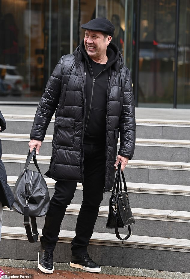 A gentleman: The former England goalkeeper was seen carrying the travel bags of the two lovebirds