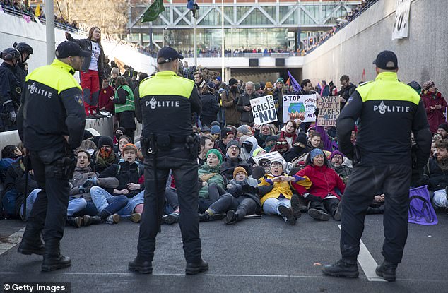 1674940237 944 Hundreds of Extinction Rebellion protesters wave banners outside The Hague