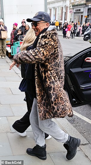 Good cheer: The former Strictly Come Dancing star turned heads in a gray tracksuit ensemble, which she teamed with an animal print faux fur jacket