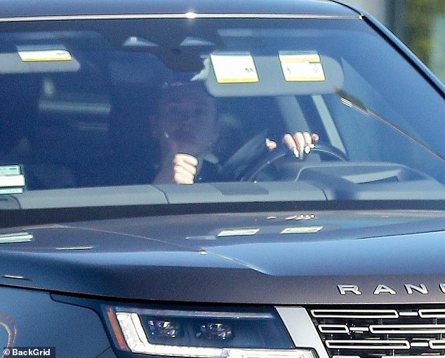 Thumbs up!  The 34-year-old singer cut a sporty figure in a black hoodie as she was seen leaving the gym in her new Range Rover.