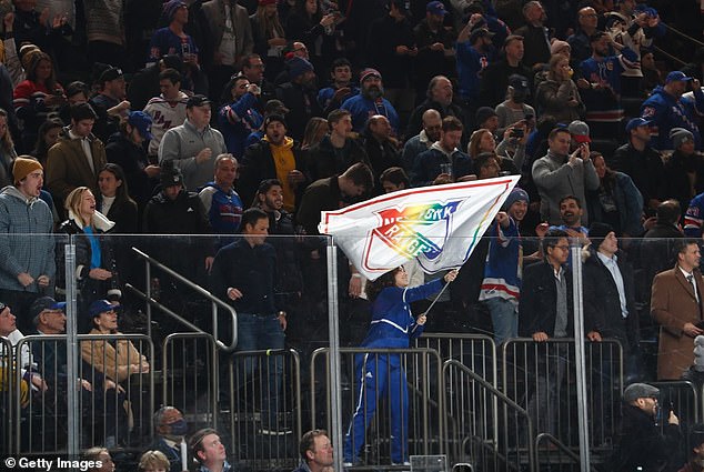 Members of the Rangers Blue Crew use special flags during Pride Night in January 2022