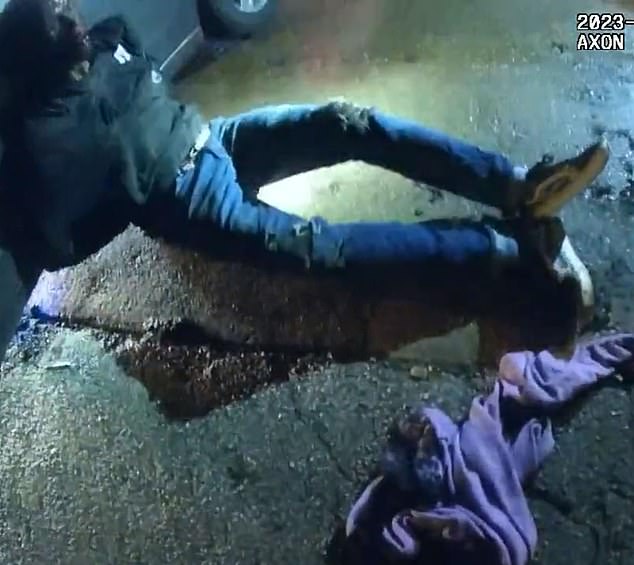 Nichols is seen leaning against the car, bloody and barely conscious.