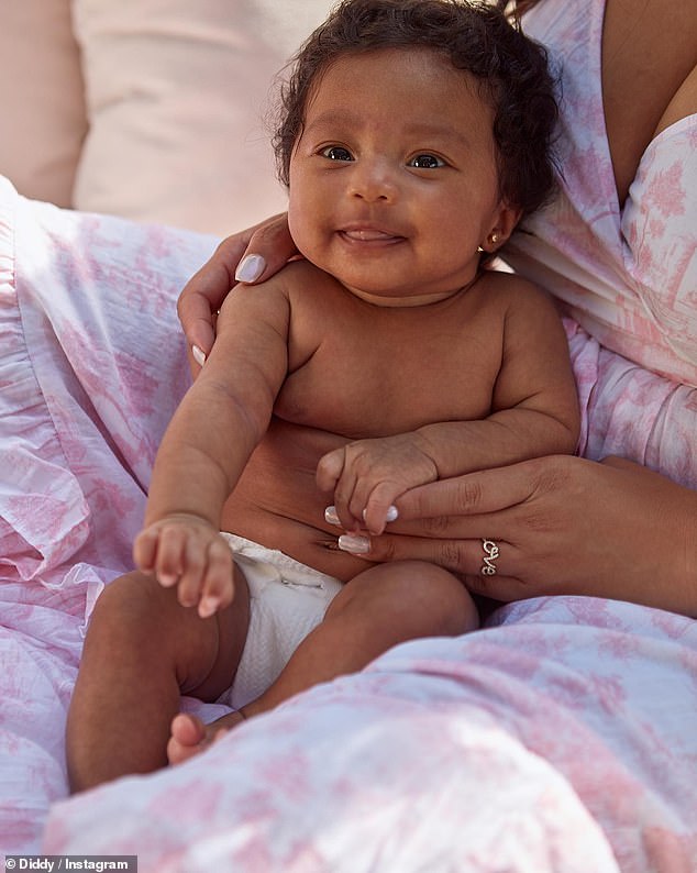 Precious: The second photo showed Love in just a diaper sitting on the lap of a woman, presumably her mother, Dana Tran.