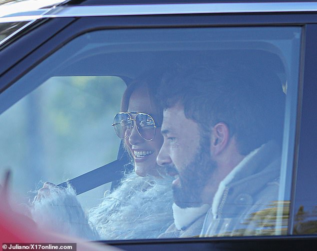 Enjoying each other: The two lovebirds shared a laugh as they got ready to leave in their car