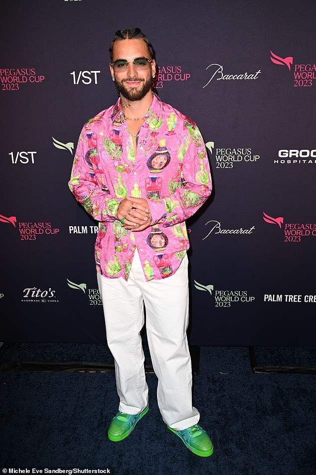 Standout: Maluma donned a festive pink patterned shirt, as well as a set of white pants and bright green shoes.