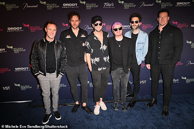 All together now: OneRepublic members stayed close to each other while posing for a group photo