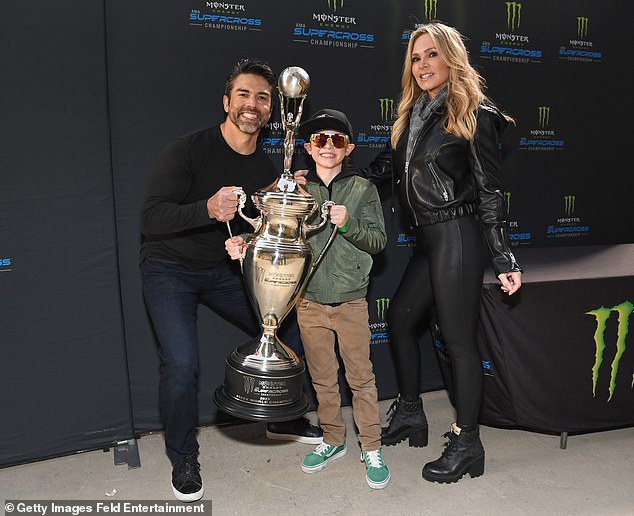 Grand Prize: He held part of the trophy while one of Tamra's sons held the other side of the shiny trophy.