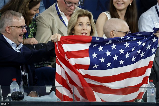 Mr. Albanese (pictured right) watches as US Ambassador Caroline Kennedy waves her compatriot Tommy Paul's flag in the men's semifinal of the Australian Open on Friday night.